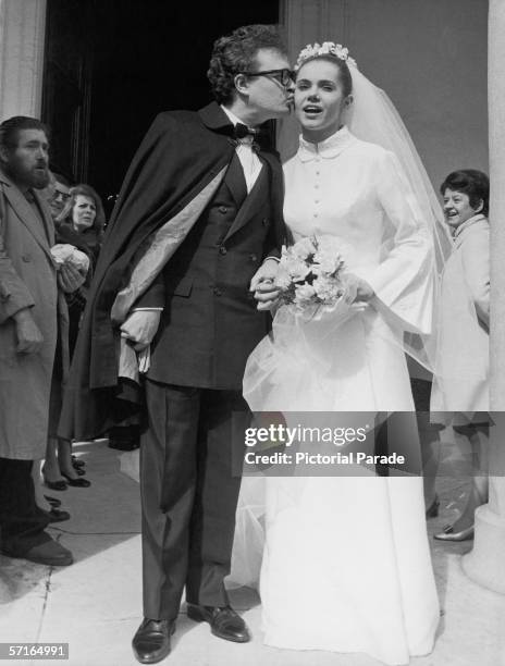 Onlookers watch as French singer and actor Patrick Font kisses his new bride, French poetess Minou Drouet, outside the Sainte-Marie des Batignolles...