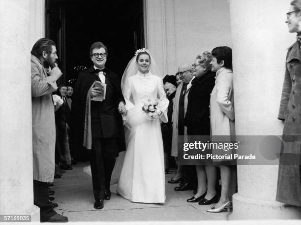 Onlookers watch as newly married French couple, singer and actor Patrick Font and his bride, poetess Minou Drouet leave the Sainte-Marie des...