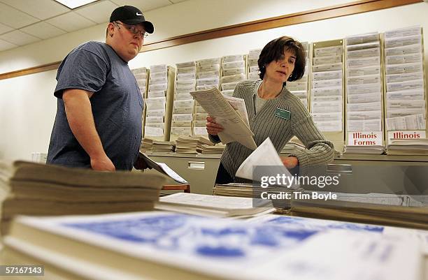 Readers' services assistant Cathy Friedman assists Edward Thomas with finding his tax forms at the Des Plaines Public Library March 23, 2006 in Des...