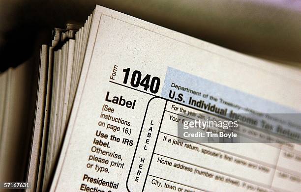 The top of a form 1040 individual income tax return for 2005 is seen atop a stack on the same at the Des Plaines Public Library March 23, 2006 in Des...