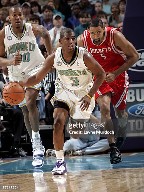 Chris Paul of the New Orleans/Oklahoma City Hornets dribbles the ball past Juwan Howard of the Houston Rockets during a game on March 23, 2006 at the...