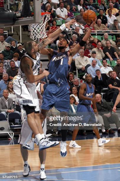 Jared Jeffries of the Washington Wizards gets to the hoop against Carlos Boozer of the Utah Jazz on March 23, 2006 at the Delta Center in Salt Lake...