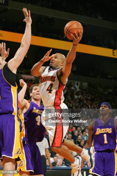 Derek Fisher of the Golden State Warriors goes to the basket against the Los Angeles Lakers at the Arena in Oakland on March 3, 2006 in Oakland,...