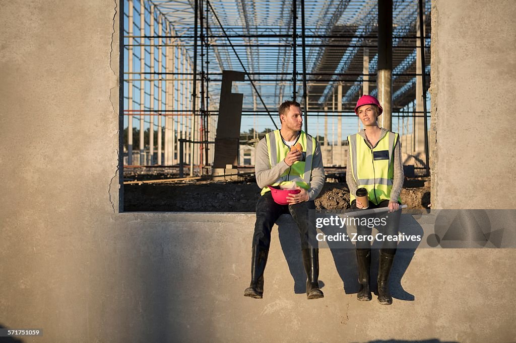 Builder and architect taking a break on construction site