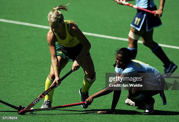 Asunta Lakra of India challenges Kate Hollywood of Australia during the Women's Gold Medal hockey match between Australia and India at the State...