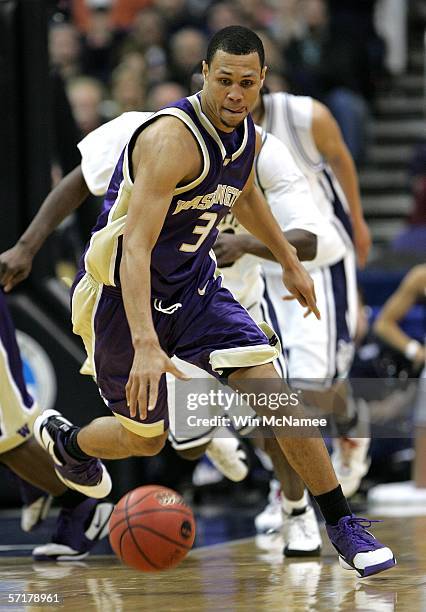 Brandon Roy of the Washington Huskies drives the ball against Connecticut Huskies during the Regionals of the NCAA Men's Basketball Tournament on...