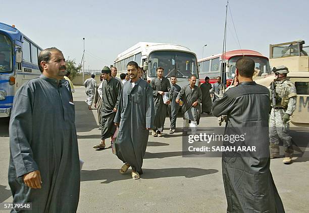 Soldier guards freed Iraqi prisoners after they were released from Abu Ghraib prison in Baghdad, 25 March 2006. Some 4,500 are held in the US-...
