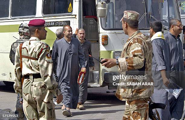 Iraqi soldiers guide freed Iraqi prisoners after they were released from Abu Ghraib prison in Baghdad, 25 March 2006. Some 4,500 are held in the US-...