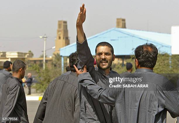 Freed Iraqi prisoner gestures after he was released from Abu Ghraib prison in Baghdad, 25 March 2006. Some 4,500 are held in the US- controlled...