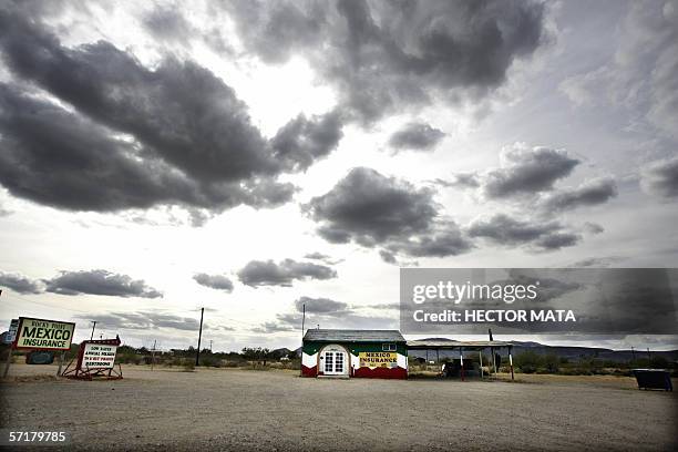 Lukeville, UNITED STATES: A house that sells car insurance for Mexico is painted with the colors of the Mexican flag in Lukeville, Arizona 21 March...