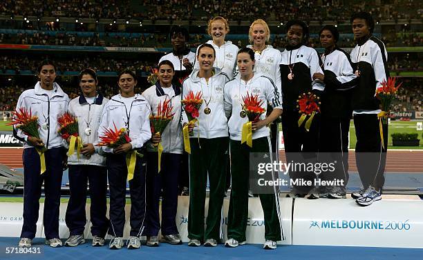 Jana Pitman, Caitlin Willis, Tamsyn Lewis and Rosemary Hayward pose for a picture next to the Indian team and Nigerian team during the medal ceremony...