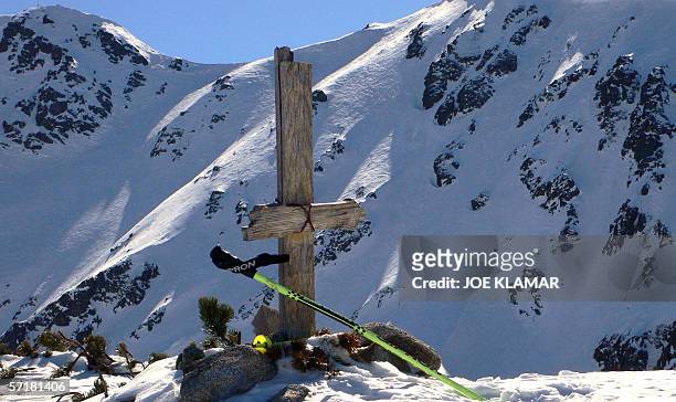 An old wooden cross and a broken ski pole, the reminders of a tragic accident that involved a young man, overlook the Dumbier mountain in the...