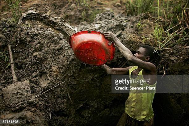 Man mines for gold near a river March 24, 2006 in Bunia, Congo. Gold deposits, which are numerous in the volatile north-east of the country, have...