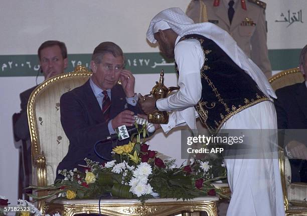 Britain's Prince Charles is served Arabic coffee as he attends the awarding of the First Prince Sultan bin Salman Prize for Urban Heritage, on the...