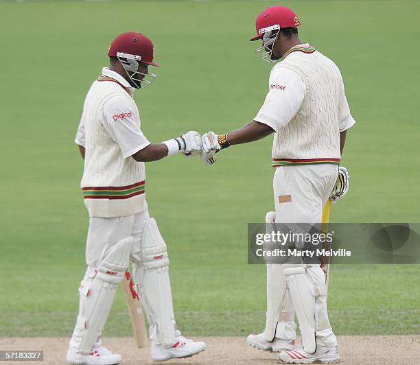 Brian Lara with team mate Runaco Morton of the West Indies celebrate Brian Lara's 4 during day two of the third test match between New Zealand and...