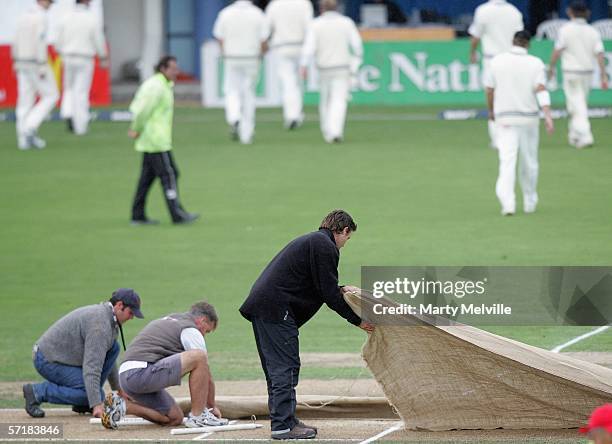 The New Zealand Black Caps walk from the field as the covers go on after rain delayed play during day two of the third test match between New Zealand...