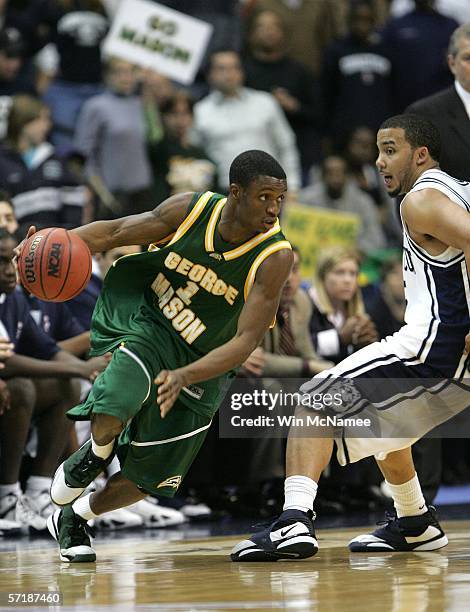 Tony Skinn of the George Mason Patriots drives with the ball against Marcus Williams of the Connecticut Huskies during the Regional Finals of the...