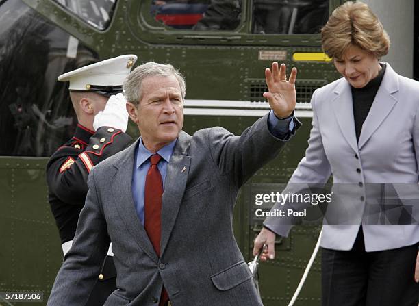 President George W. Bush waves as he and his wife, first lady Laura Bush, depart from Marine One as they arrive at the White House March 26, 2006 in...