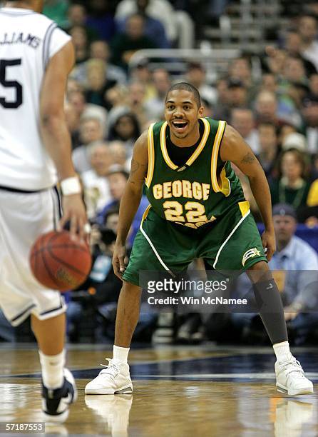 Lamar Butler of the George Mason Patriots looks to defend against Marcus Williams of the Connecticut Huskies during the Regional Finals of the NCAA...