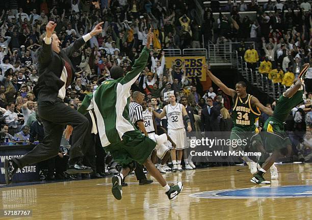 The George Mason Patriots celebrate their overtime victory over the Connecticut Huskies during the Regional Finals of the NCAA Men's Basketball...