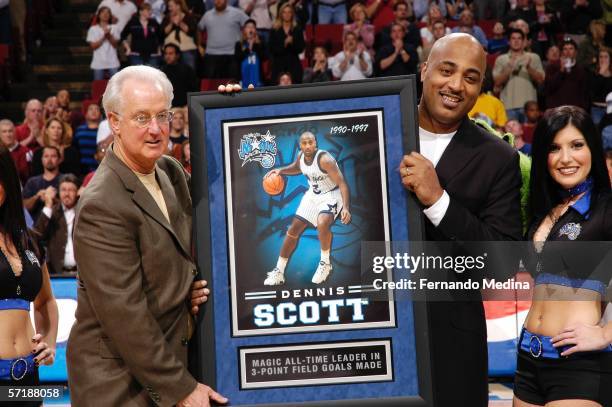 Former Orlando Magic player Dennis Scott is honored by the team during a break in action with Pat Williams , Magic senior vice president and a Magic...