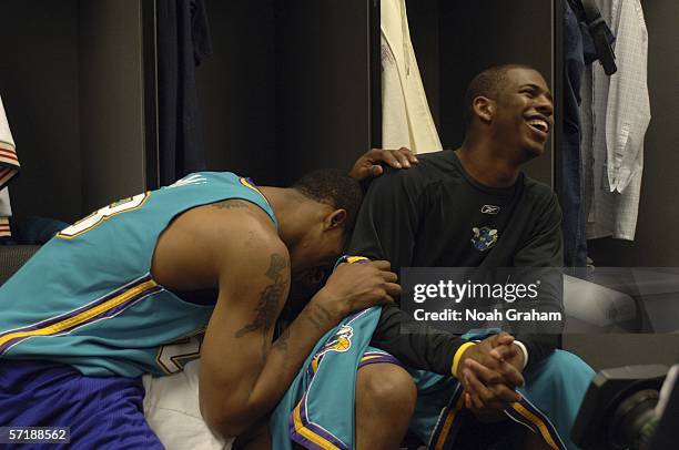 Smith of the New Orleans/Oklahoma City Hornets jokes with teammate Chris Paul in the locker room before the game against the Los Angeles Lakers on...