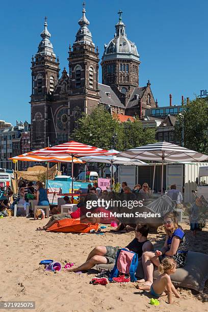 public beach in front of central station - strand amsterdam stock pictures, royalty-free photos & images
