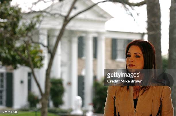 Priscilla Presley listens to Secretary of the Interior Gale Norton address a group of Elvis fans on the front lawn of Graceland March 27, 2006 in...