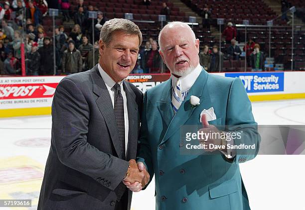 Head coach Bobby Orr of Team Orr smiles and head coach Don Cherry of Team Cherry shake hands after Orr's team won the CHL Top Prospects game 7-2 at...