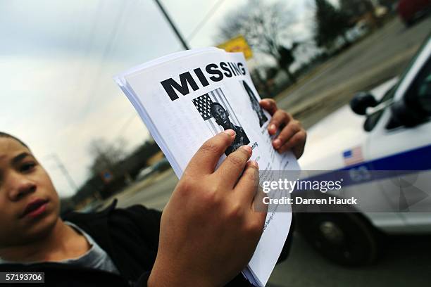 Quinn Harris, 10-years-old, volunteers his time and hands out flyers with his mother at the intersection of 51st and Hampton near the home of the...