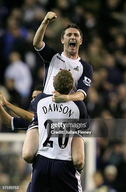 Robbie Keane of Tottenham Hotspur is lifted into the air by teammate Matt Dawson as they celebrate their team's victory at the end of the Barclays...