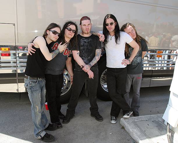 Members of Shinedown drummer Barry Kerch, guitarist Jasin Todd, vocalist Brent Smith, and bassist Brad Stewart, and an unidentified man pose for...