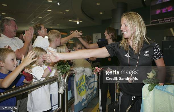 Bronze medalist Hannah McLean is welcomed home by members of the North Shore swim group upon her arrival with the New Zealand athletes from the...