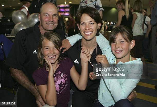 Bronze medalist in high jump Angela McKee poses with her husband and coach Kieran and their two daughters, Kimberly and Alexia after arriving home...