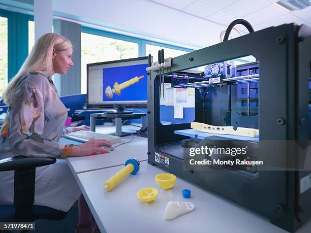 medical product designer with 3d printing machine with cad design on screen in orthopaedic factory - 3d printer female stock-fotos und bilder