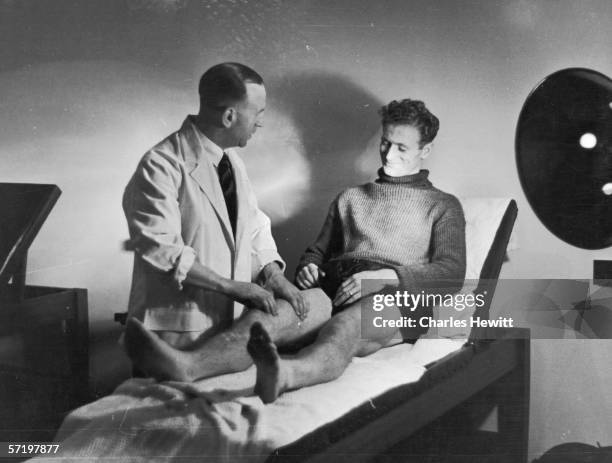 Preston North End footballer Tom Finney receiving treatment from the club physio, 2nd November 1946. Original Publication - Picture Post - 4243 -...