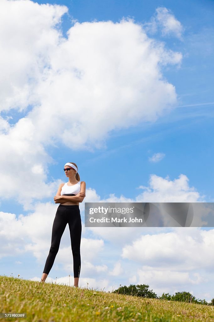 Portrait of jogger against blue skies of countryside