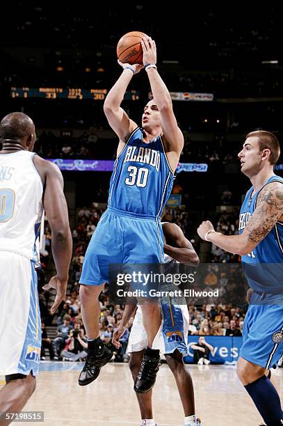 Carlos Arroyo of the Orlando Magic shoots against the Denver Nuggets on March 4, 2006 at the Pepsi Center in Denver, Colorado. The Nuggets won...
