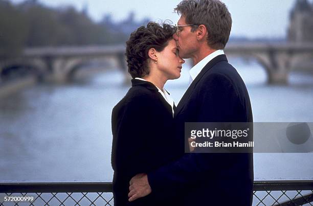 British actress Julia Ormond and American actor Harrison Ford on a bridge in the film 'Sabrina' , 1995.