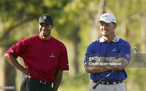 Tiger Woods and Ernie Els of South Africa share a laugh on the 18th hole during the second day of the Tavistock Cup at the Isleworth Golf and Country...