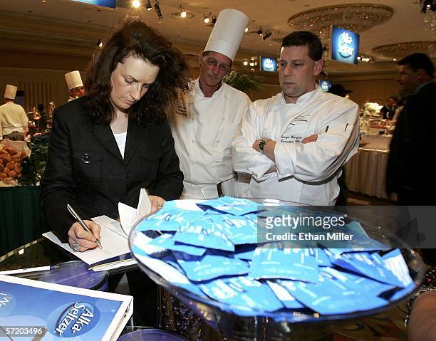 Guinness World representative Nadine Causey, seen behind a bowl of Alka-Seltzer tablets, makes a final count of the number of items in a buffet at...