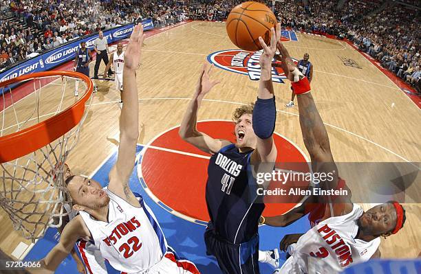 Dirk Nowitzki of the Dallas Mavericks shoots a layup against Ben Wallace and Tayshaun Prince of the Detroit Pistons at the Palace of Auburn Hills on...