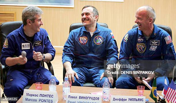 Brazilian astronaut Marcos Pontes , Russian cosmonaut Pavel Vinogradov and US astronaut Jeffrey Williams smile during their joint news conference in...