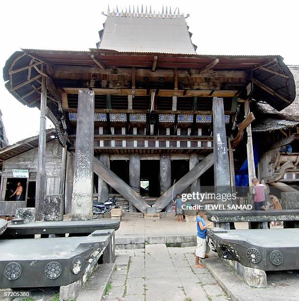 Children play in front of their ancient houses in Siwahili village, on Nias island, 09 March 2006. More than 200 magnificent traditional dwellings...