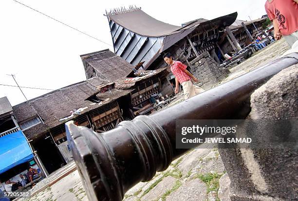 Villagers walk around in Siwahili, on Nias island, 09 March 2006. More than 200 magnificent traditional dwellings remaining in the village, which are...