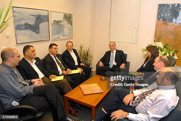 Israeli Acting Prime Minister Ehud Olmert meets with his executive staff in the prime minister's office the day after leading his Kadima party to...