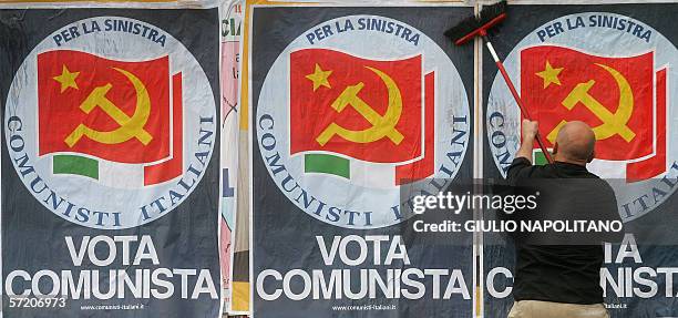Sticks electoral posters of the Italian communist party , in Rome 29 March 2006. The last opinion polls before Italy's April elections predicted...