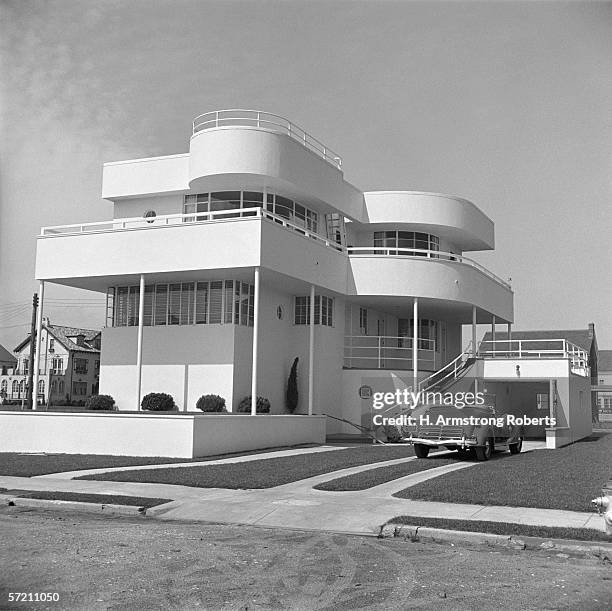 1930s: Stucco Art Deco beach house, convertible car in driveway, Margate City, New Jersey.