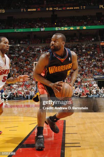 Baron Davis of the Golden State Warriors holds the ball against the Miami Heat at American Airlines Arena on March 10, 2006 in Miami, Florida. The...