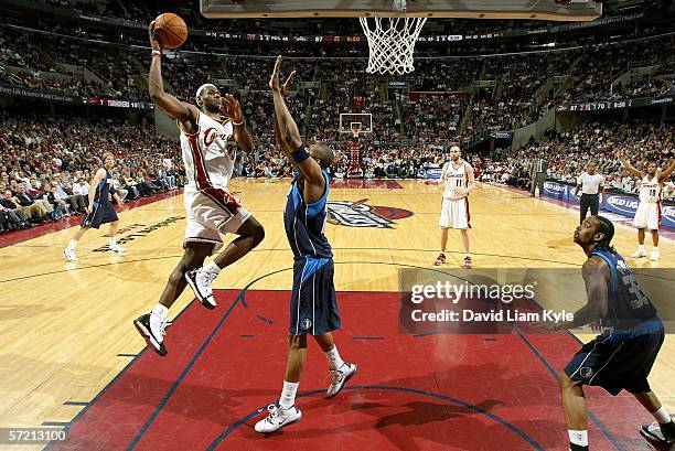Lebron James of the Cleveland Cavaliers goes in for the dunk over Erick Dampier of the Dallas Mavericks on March 29, 2006 at The Quicken Loans Arena...